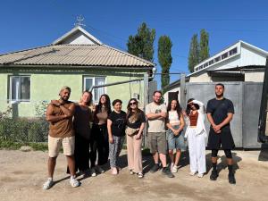 a group of people standing in front of a house at Guest House Datka-Ayim in Kochkorka