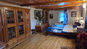 a bedroom with a bed and wooden cabinets at Zacisze 13 in Leśna