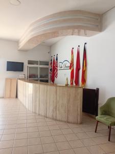 a lobby with several flags on a wall at Appart-Hotel Cabodream beach in Tétouan
