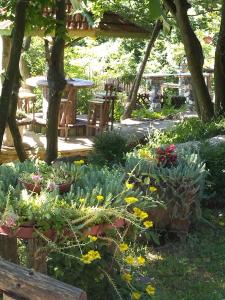 a garden with a table and chairs and flowers at Cabin Hill Station Queen in Sarajevo