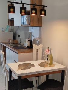 a kitchen with a table with a vase on it at Kovács-Otthon in Vásárosnamény
