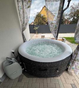 a large bath tub sitting in a yard at Kovács-Otthon in Vásárosnamény
