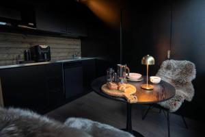 a kitchen with a table with food on it at Compact Cabin for Remote Work and Adventures in Yllas in Kolari +21 photos
