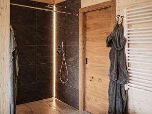 ein Badezimmer mit Dusche mit Glastür in der Unterkunft Romantikchalet Vogelnest mit Whirlpool, Kamin, Balkon & Terrasse in Vorra