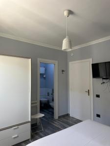 a bedroom with a bed and a room with a bathroom at B&B Ponza Suite in Ponza