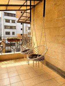 two chairs are hanging on a balcony at Riverside Penthouse in Dilijan in Dilijan +8 photos
