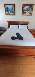 a bedroom with a bed with a shirt on it at Cosy Haven - Large Comfy Dwelling in Mandurah