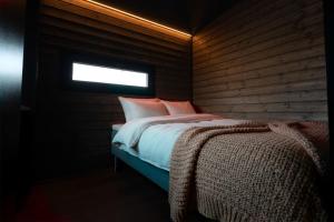 a bedroom with a bed in a room with a window at Yllas Cabin for Work, Ski and Relax in Kolari