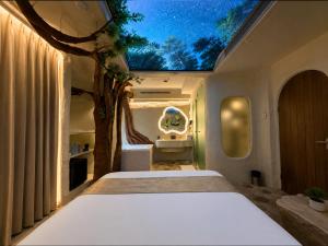 a bedroom with a bed with a tree on the ceiling at Dragonfly Hotel - The Art Hotel in Mumbai