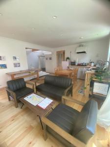 a living room with a couch and a table at Magical Skate Casa in Wakayama