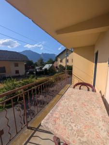 a balcony with a table and chairs and mountains at La cascade de Grignon - Appartement - Pizzeria - Parking Vélos - Room Service in Grignon