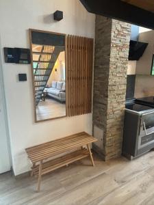 a wooden bench in a room with a mirror at SchiScho's Lodge in Sankt Kathrein am Offenegg