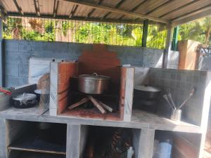 a kitchen with pots and pans in a building at Gite, Route Des Laves in Saint-Philippe