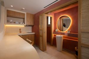 a bathroom with a sink and a mirror at Gea Perla Serifos in Livadi +91 photos