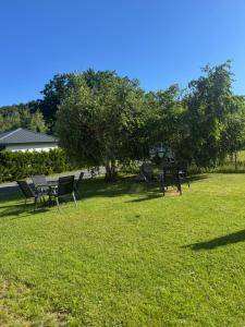 a group of chairs and tables in a park at Hawira in Mielno +19 photos