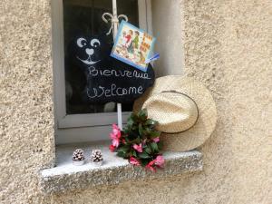 LaurisにあるLa Petite Maison de Marie Louiseの藁帽子と花の窓