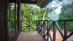 a view from the inside of a house with a wooden balcony at Samwise Escapade Hillside Guesthouse - Master Room in Kampong Perlis