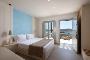 a bedroom with a bed and a view of the ocean at Gea Perla Serifos in Livadi