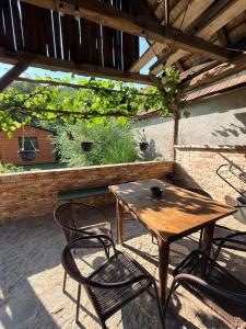 a wooden table and chairs on a patio at Ubytovanie Lišov 3 - Tiny House in Lišov