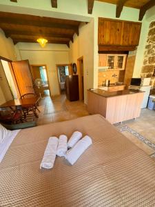 a bedroom with a bed with two towels on it at Kyma in Gerolimenas