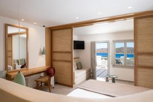 a bedroom with a view of the ocean at Gea Perla Serifos in Livadi