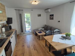 a kitchen and living room with a couch and a table at A & B apartment in Lovran