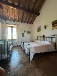 a bedroom with two beds and a window at B&B la boffalora in Zaffignano