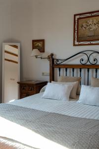 a bedroom with a large bed with two pillows at Cortijo La Presa in Priego de Córdoba