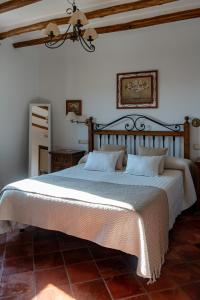 a bedroom with a large bed in a room at Cortijo La Presa in Priego de Córdoba