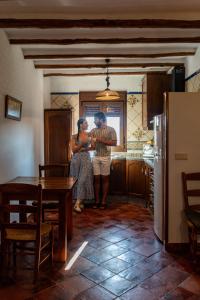 a man and a woman standing in a kitchen at Cortijo La Presa in Priego de Córdoba