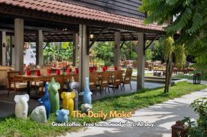 a restaurant with a group of tables and chairs at The Community - Siem Reap in Siem Reap