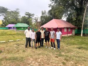 a group of men posing for a picture in front of a house at Himjoy farm in Dādo Sība