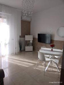 a white living room with a table and chairs at Casa Manzoni 45 in Scandicci