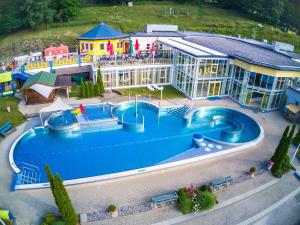 an aerial view of a resort with a large swimming pool at Sportchalet Bergkristall regio Nassfeld Presseggersee in Kirchbach