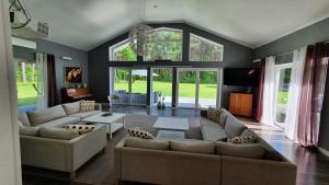 a living room with two couches and a table at Willa bankietowa z basenem in Papiernia