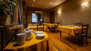 a restaurant with tables with yellow table cloths on them at Hotel Du Nord in Besançon