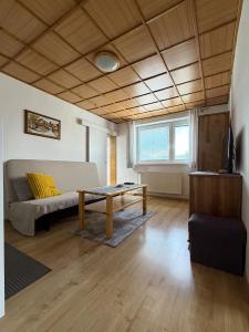 a living room with a couch and a table at Apartmány Hrady in Zuberec