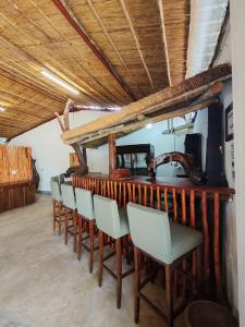 a bar with a row of chairs in a room at Masango Lodge in Hoedspruit
