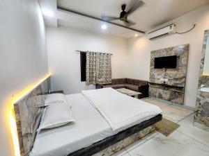 a bedroom with a large bed and a television at Hotel Shree Karni Palace in Deshnoke