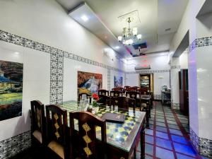 a dining room with a table and chairs at Hotel Shree Karni Palace in Deshnoke