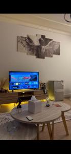 a living room with a coffee table and a tv at Ksa3 in Hail