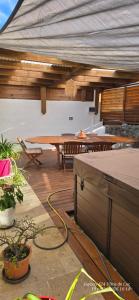 a patio with a table and chairs and a table at Superbe Suite parentale Chez l'habitant avec SPA et petit déjeuner in Saint-Pierre