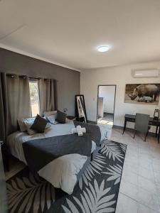 a bedroom with two beds and a rug at Masango Lodge in Hoedspruit +32 photos