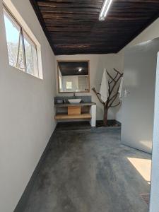 a bathroom with a sink and a mirror at Masango Lodge in Hoedspruit