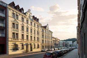 a row of buildings on a street with parked cars at Hotel Botanica by goodnite cz in Brno