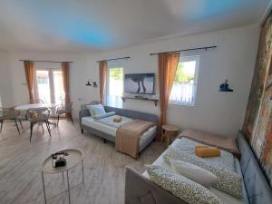 a living room with a bed and a couch at Kúria Apartman Extra in Budapest