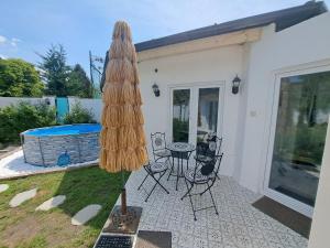a patio with a table and a umbrella at Kúria Apartman Extra in Budapest