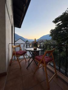 a table and chairs on a balcony with a view at Hiša Mila in Bovec