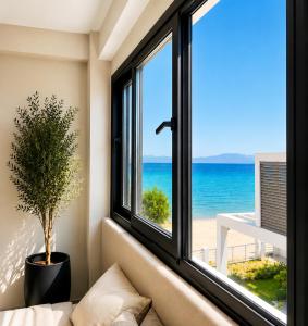 a room with a window with a view of the ocean at athanasian side sea view home in Polychrono