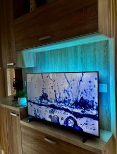 a flat screen tv sitting on top of a wooden cabinet at MARIS MOBILE HOME in Drage